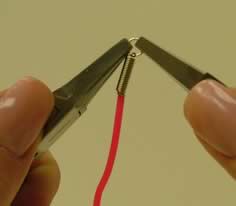 Pliers adding a jump ring to coil end